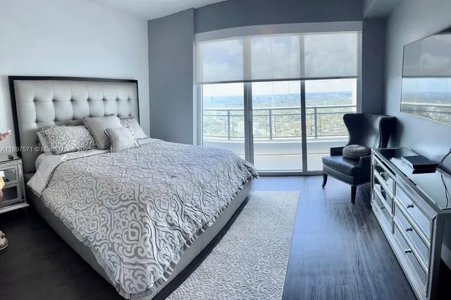 a bedroom with bed and large window