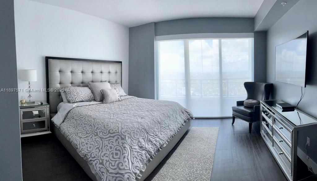 60 Southwest 13th Street, Unit 4607 Miami, FL 33130 - Photo 13 of 20 a bedroom with a bed and a window