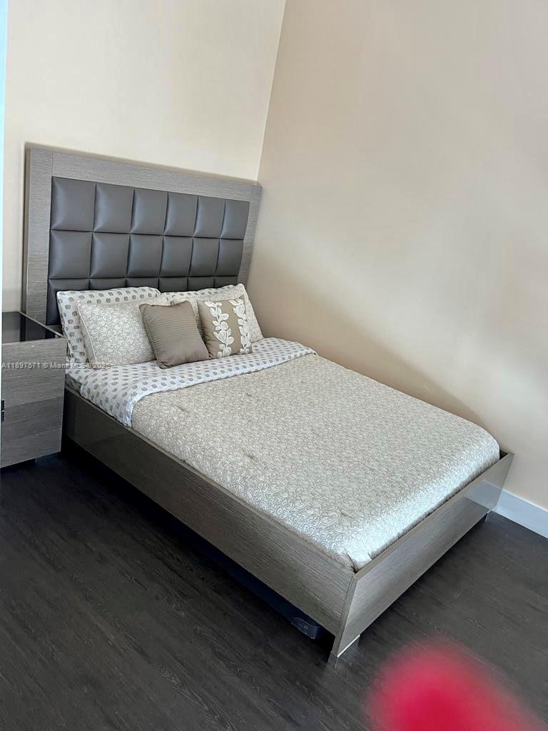 60 Southwest 13th Street, Unit 4607 Miami, FL 33130 - Photo 15 of 20 a bed sitting in a bedroom next to a larger window