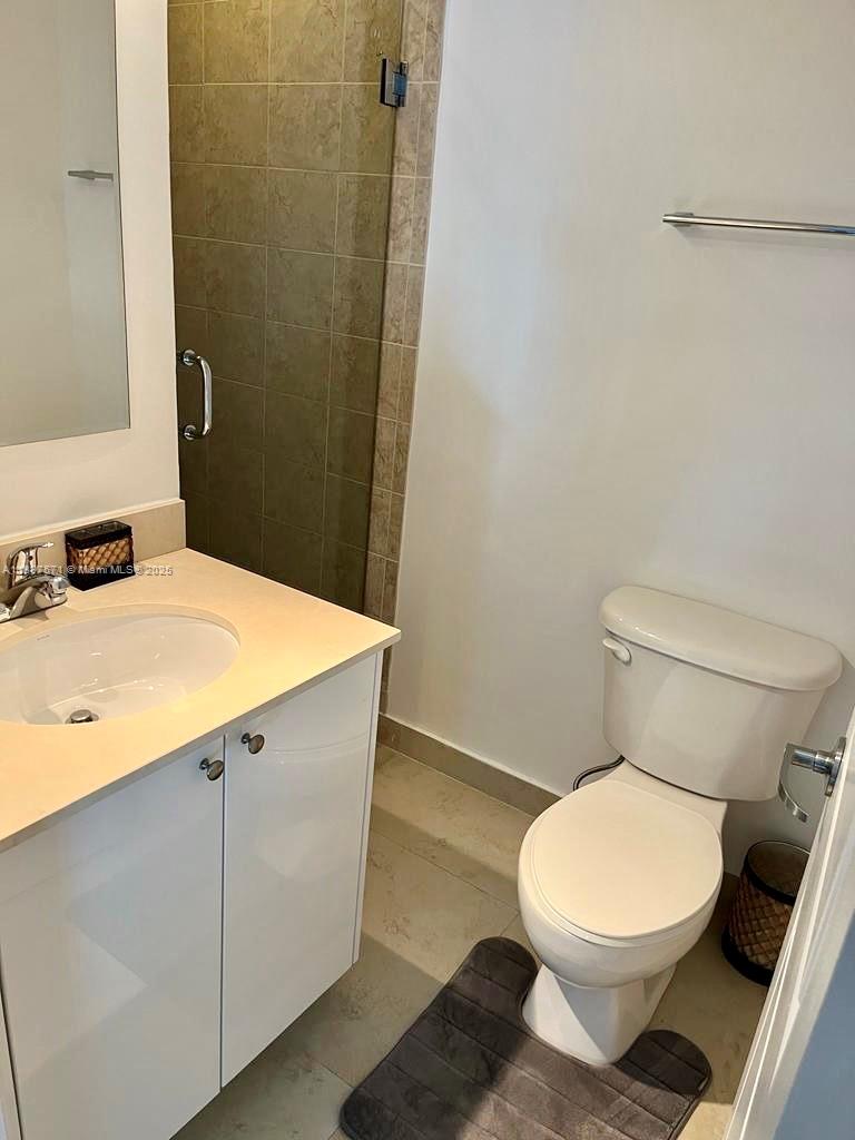 60 Southwest 13th Street, Unit 4607 Miami, FL 33130 - Photo 17 of 20 a white toilet sitting next to a bathroom sink