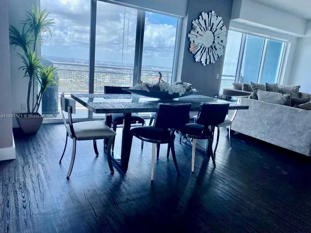 a view of a dining room with furniture window and wooden floor