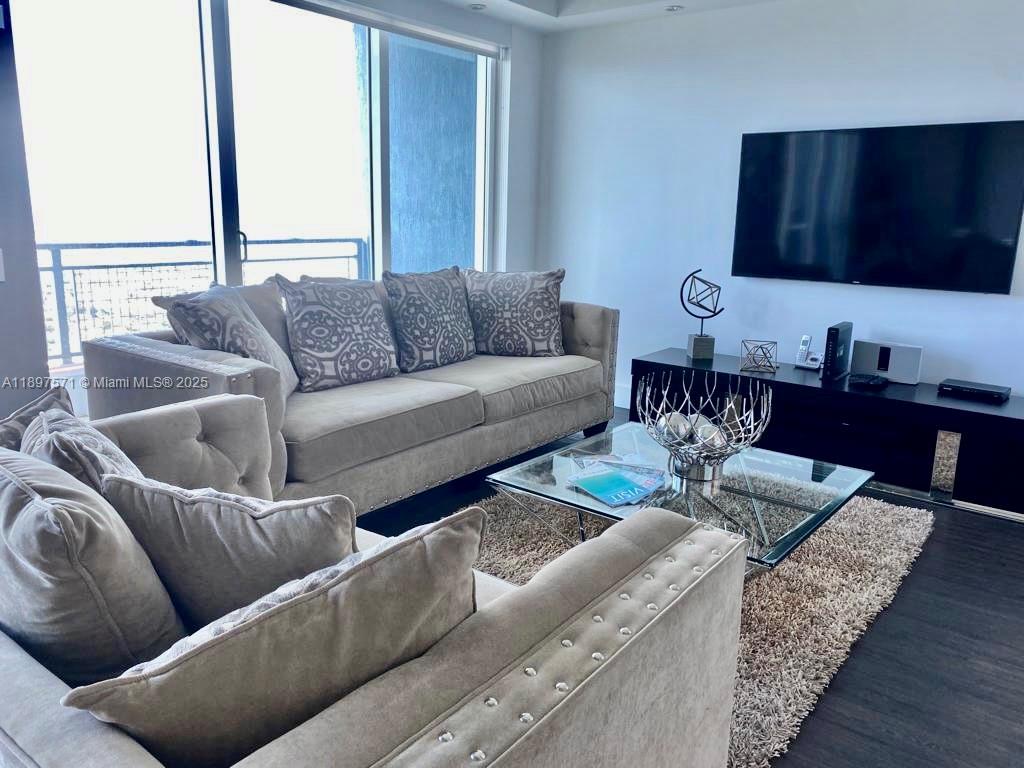60 Southwest 13th Street, Unit 4607 Miami, FL 33130 - Photo 4 of 20 a living room with furniture wooden floor and a large window