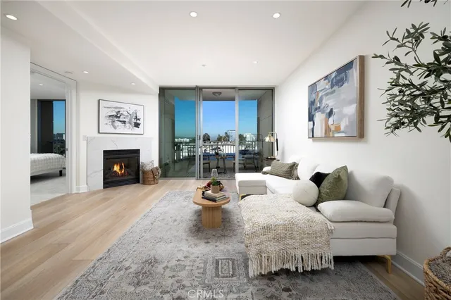 a living room with fireplace furniture and a wooden floor