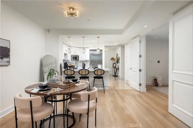 a kitchen with stainless steel appliances kitchen island granite countertop a sink refrigerator and cabinets