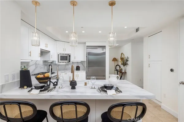 a living room with furniture and chandelier