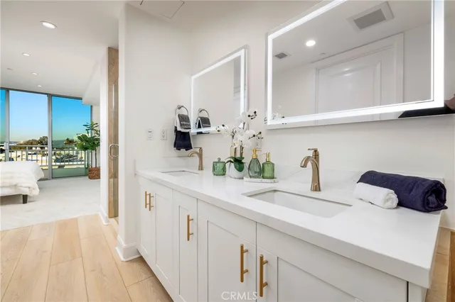 a large white bathroom with a tub a mirror and shower