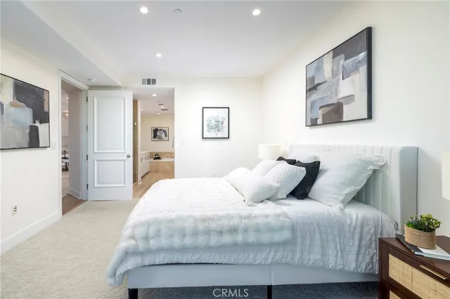 a bedroom with a bed and a potted plant