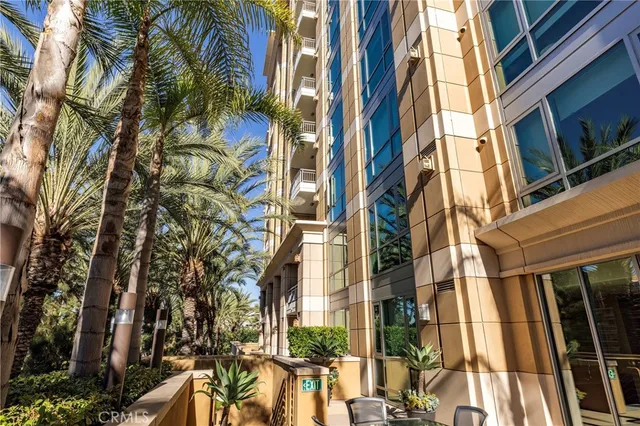 a living room with furniture and potted plants