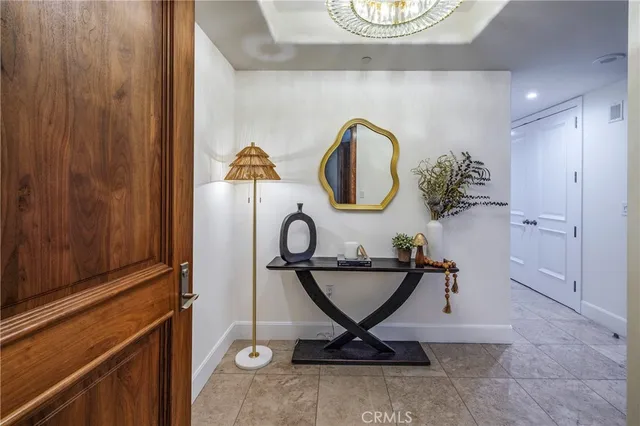 a living room with furniture a flat screen tv and kitchen view
