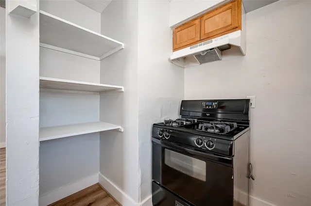 a stove top oven sitting inside of a kitchen