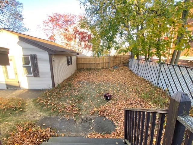 248 Shute Street Everett, MA 02149 - Photo 29 of 35 a view of a yard with wooden fence and trees