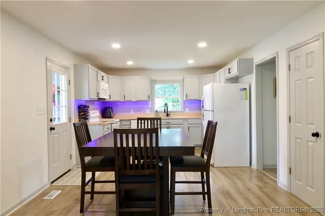 a dining room with furniture and window