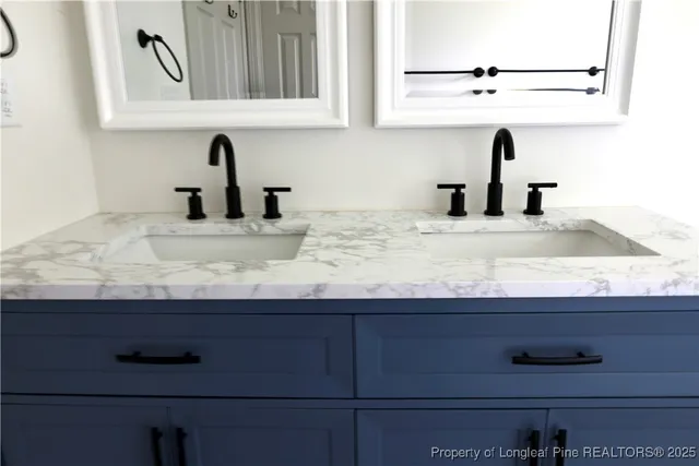 a kitchen with granite countertop white cabinets and sink