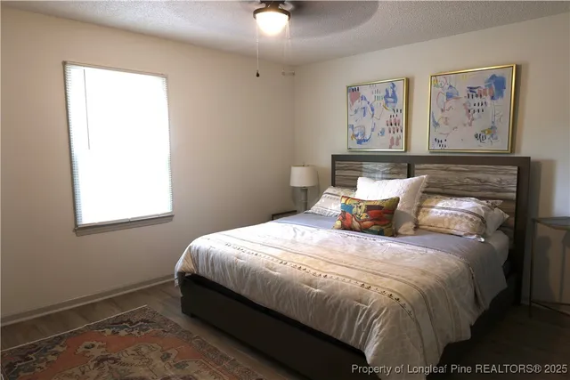 a bedroom with a bed and a window