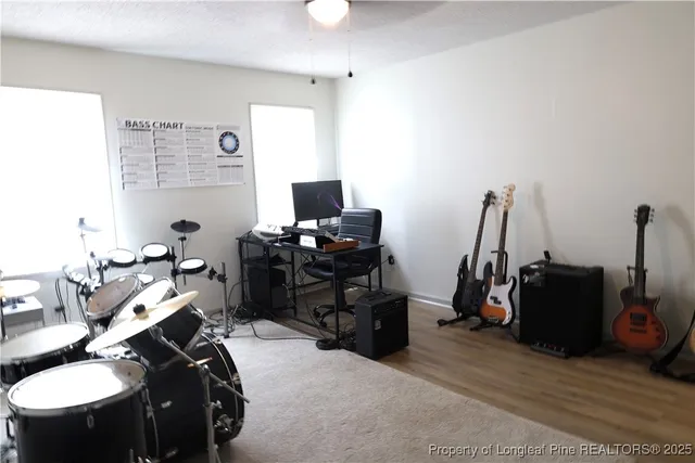 a bed room with furniture a flat screen tv and a window