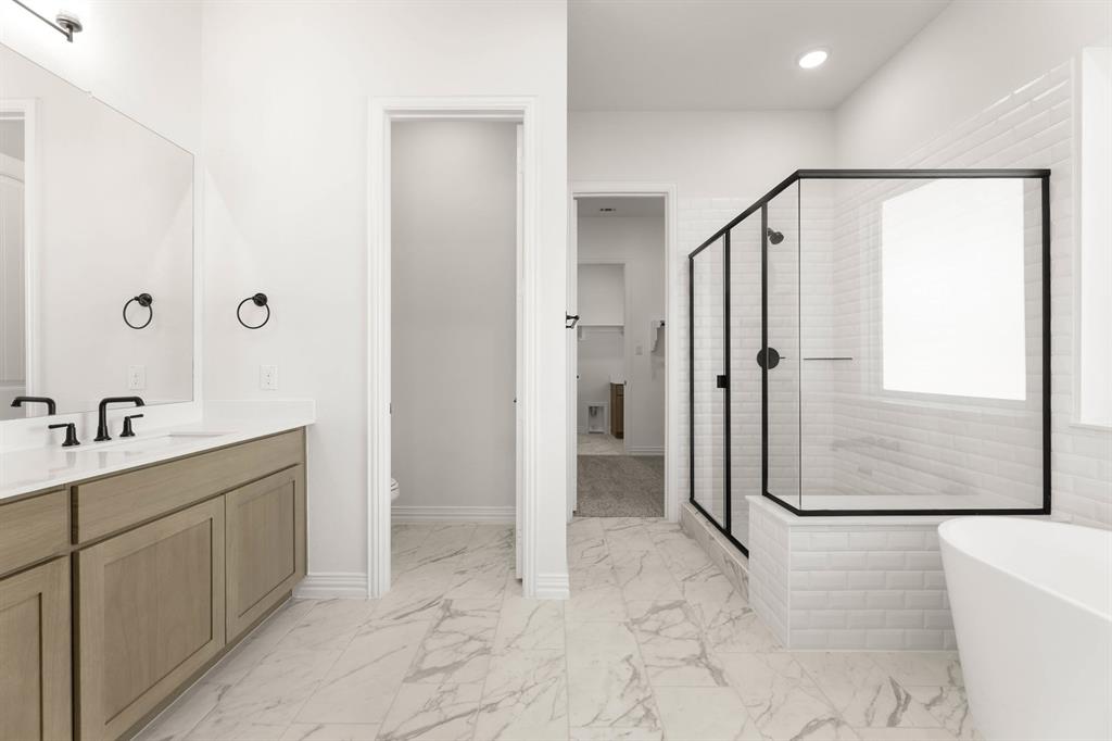 317 Slimp Bluff Azle, TX 76020 - Photo 17 of 25 a bathroom with a bathtub and a shower