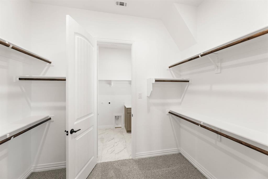 317 Slimp Bluff Azle, TX 76020 - Photo 20 of 25 a view of walk in closet with empty racks