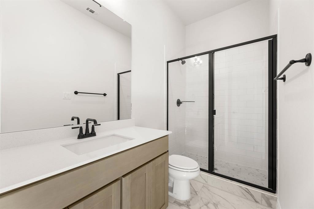 317 Slimp Bluff Azle, TX 76020 - Photo 22 of 25 a bathroom with a sink a toilet a mirror and shower