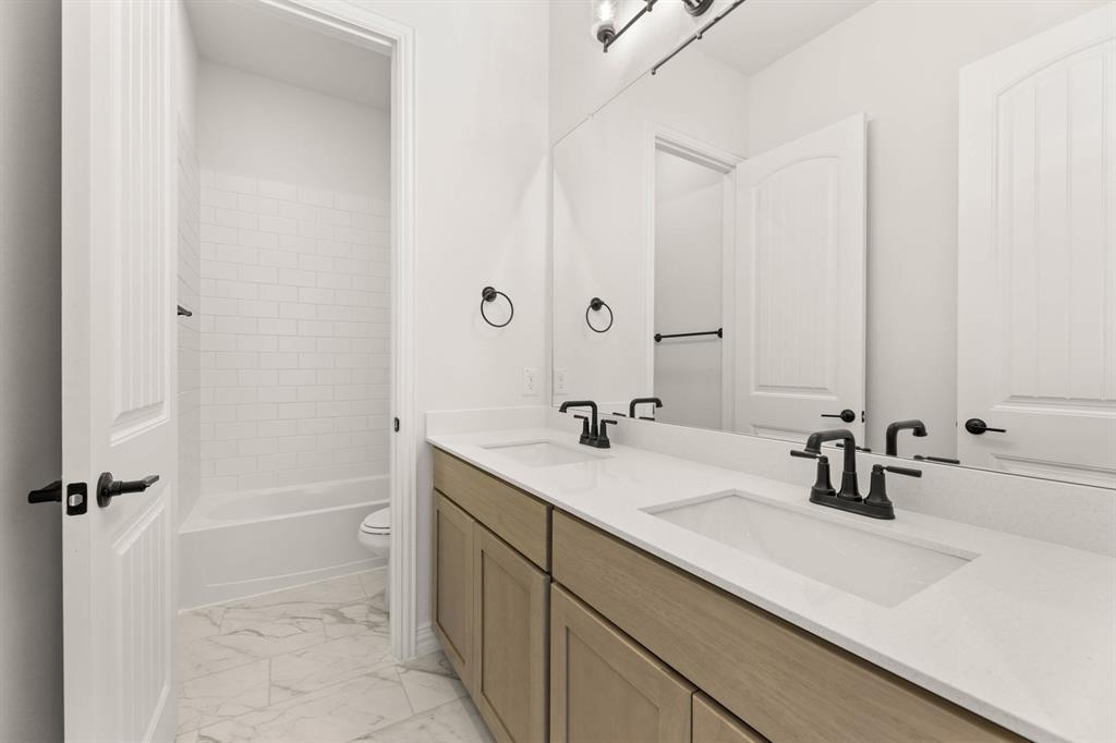 317 Slimp Bluff Azle, TX 76020 - Photo 23 of 25 a bathroom with a sink a toilet a mirror and shower