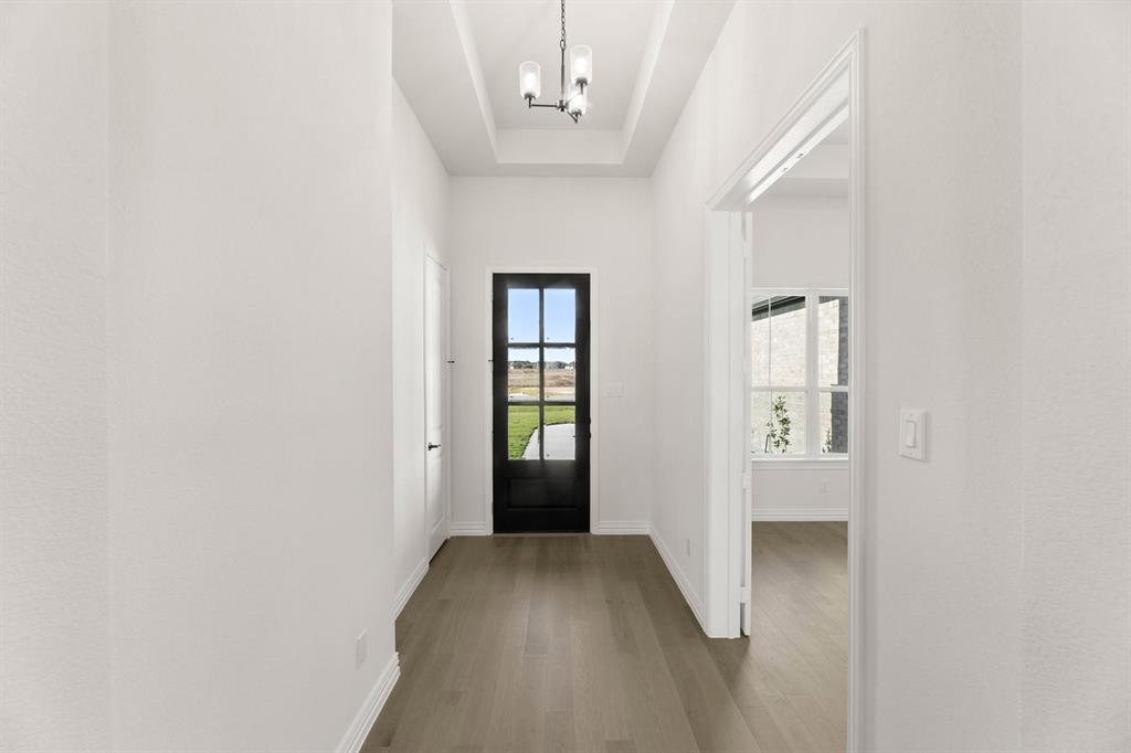 317 Slimp Bluff Azle, TX 76020 - Photo 2 of 25 a view of a hallway with wooden floor and a bathroom