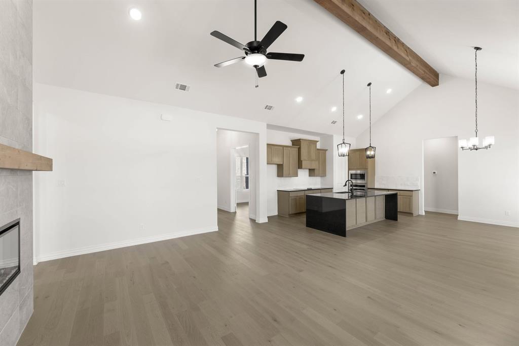 317 Slimp Bluff Azle, TX 76020 - Photo 5 of 25 a large room with kitchen view and a ceiling fan