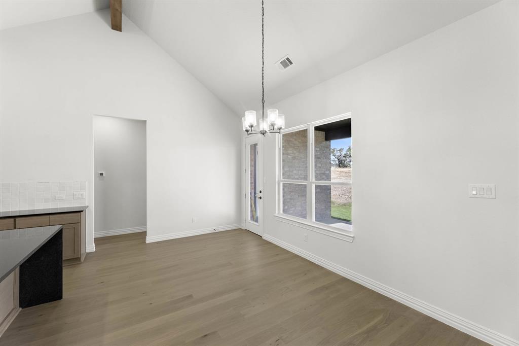 317 Slimp Bluff Azle, TX 76020 - Photo 6 of 25 a view of an empty room with chandelier fan and fire place