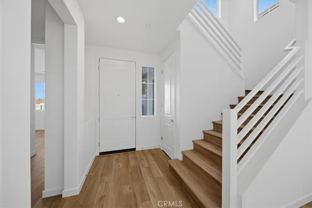 a view of entryway with wooden floor and stairs