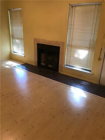 a view of empty room with window and fireplace
