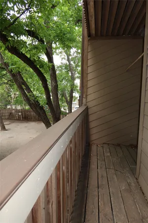 a view of a balcony with wooden floor