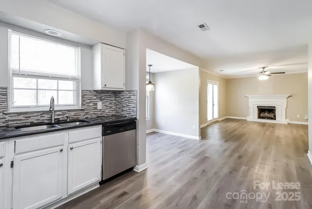 a kitchen with granite countertop a sink and cabinets