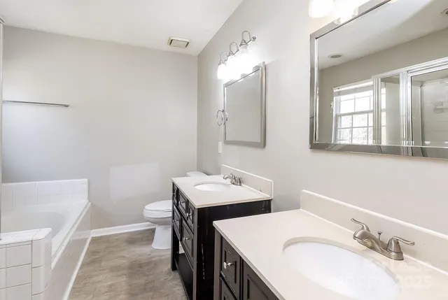 a bathroom with 2 sink and a mirror