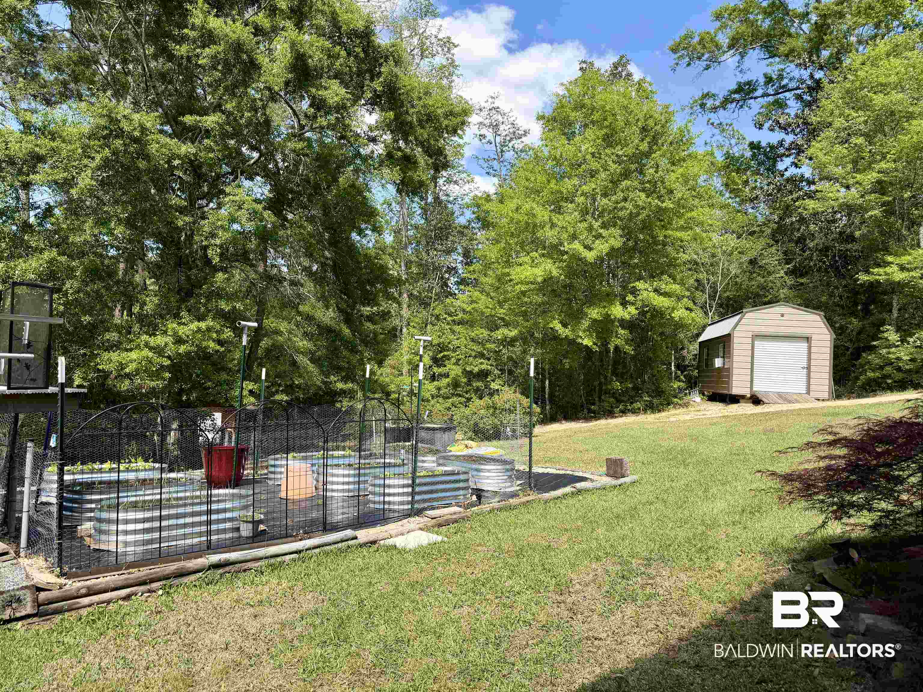 2944 Appleton Road Brewton, AL 36426 - Photo 50 of 65 View of green lawn with view of wooded area and a storage shed