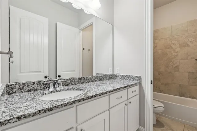 an aerial view of a residential houses with outdoor space and a lake view