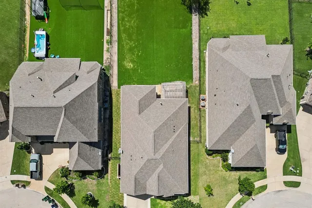 an aerial view of a house with a garden and swimming pool