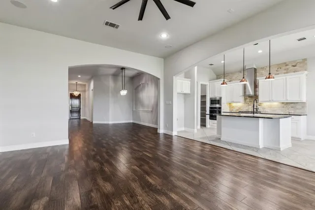 a kitchen with stainless steel appliances granite countertop a stove and refrigerator