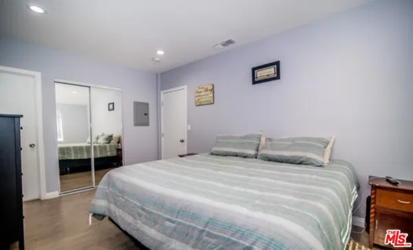 a bedroom with a bed and a tv