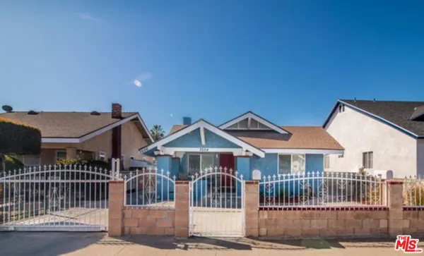 a front view of a house with iron fence