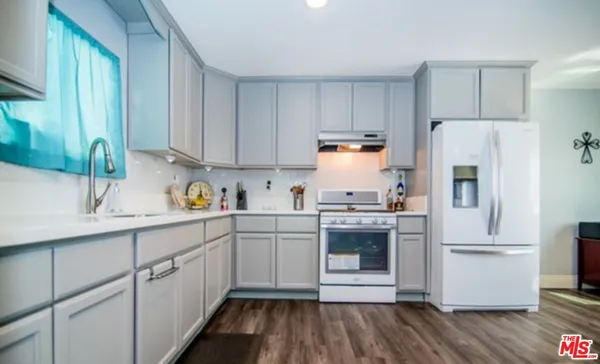 a kitchen with a sink cabinets stainless steel appliances and cabinets