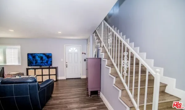 a view of entryway and hall with wooden floor