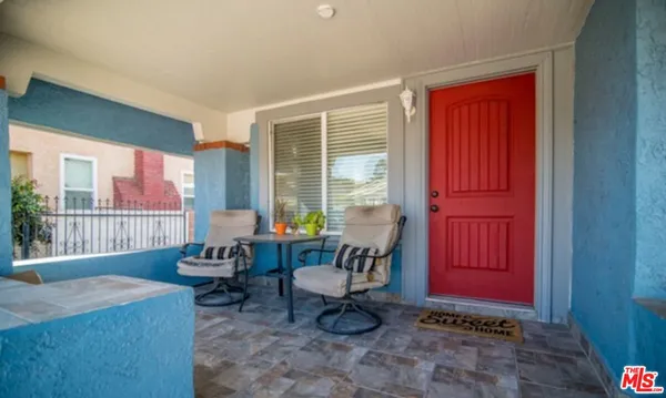 a living room with furniture a window and a potted plant