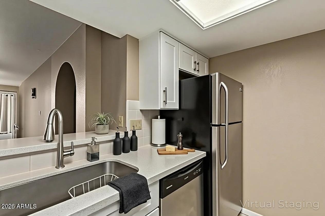 10410 North Cave Creek Road, Unit 1230 Phoenix, AZ 85020 - Photo 2 of 13 a kitchen with a refrigerator and a sink