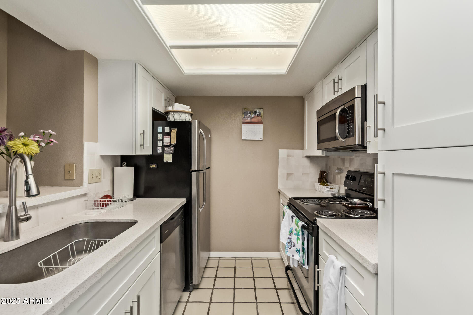 10410 North Cave Creek Road, Unit 1230 Phoenix, AZ 85020 - Photo 3 of 13 a kitchen with a sink stove top oven and refrigerator