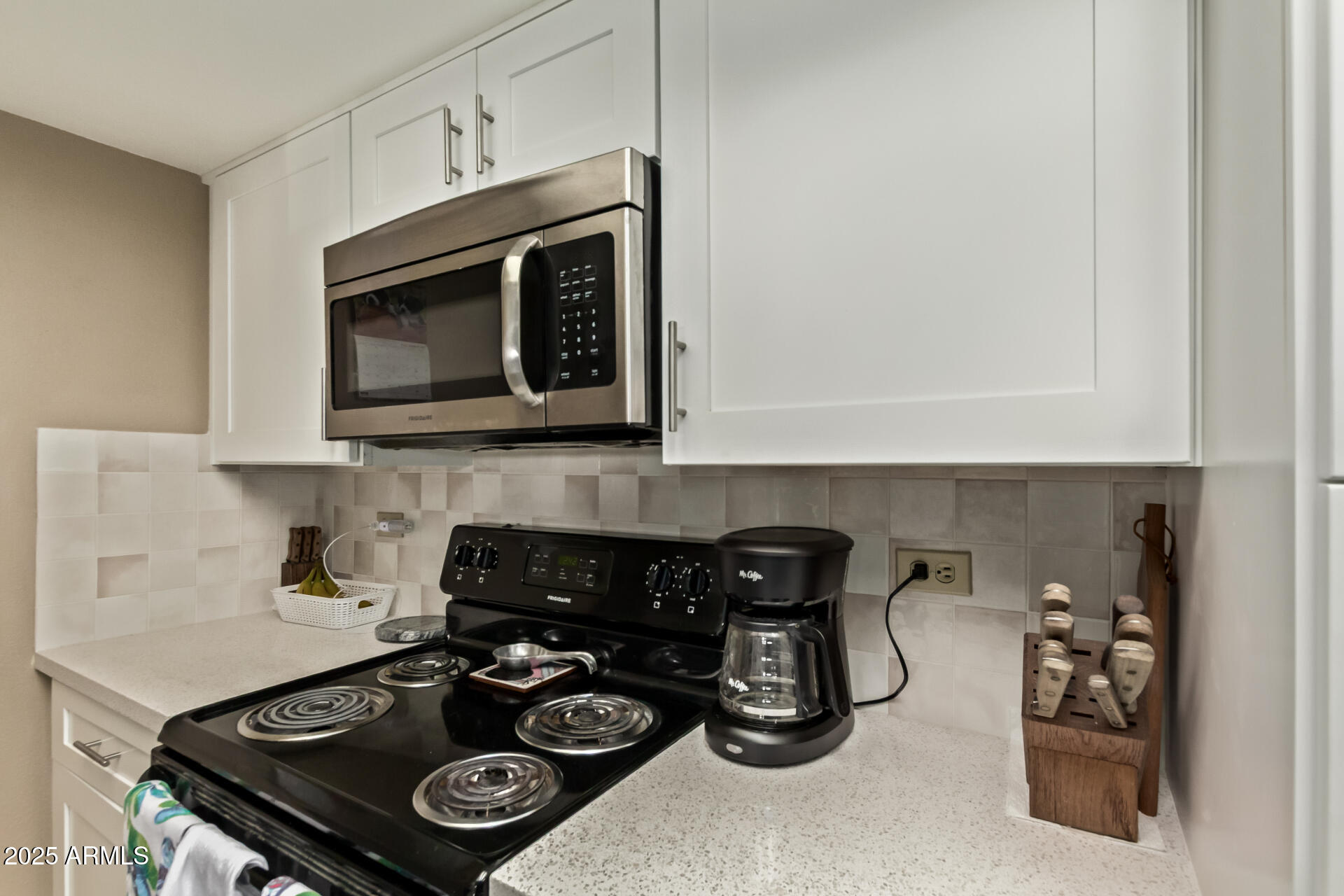 10410 North Cave Creek Road, Unit 1230 Phoenix, AZ 85020 - Photo 4 of 13 a kitchen with a stove and a microwave