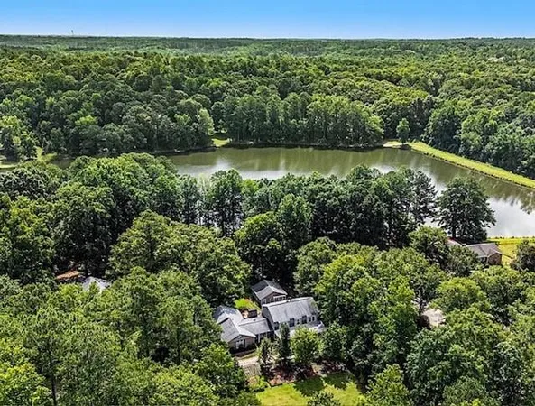an aerial view of a houses with a yard