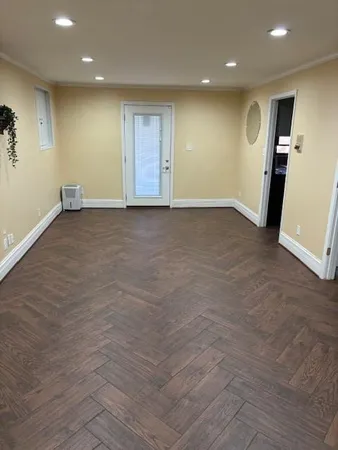 an empty room with closet and mirror