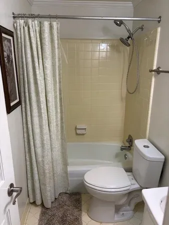 a bathroom with a toilet and shower