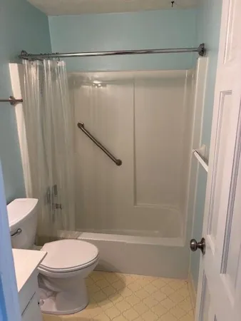 a bathroom with a toilet and a shower