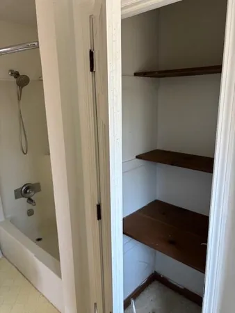 a bathroom with a toilet and a tub