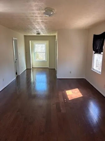 an empty room with wooden floor