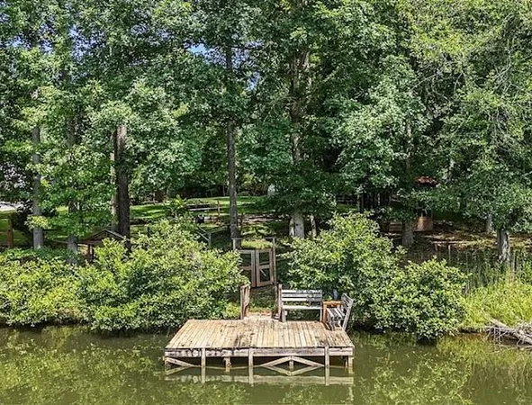 a wooden bench sitting in the middle of a lake